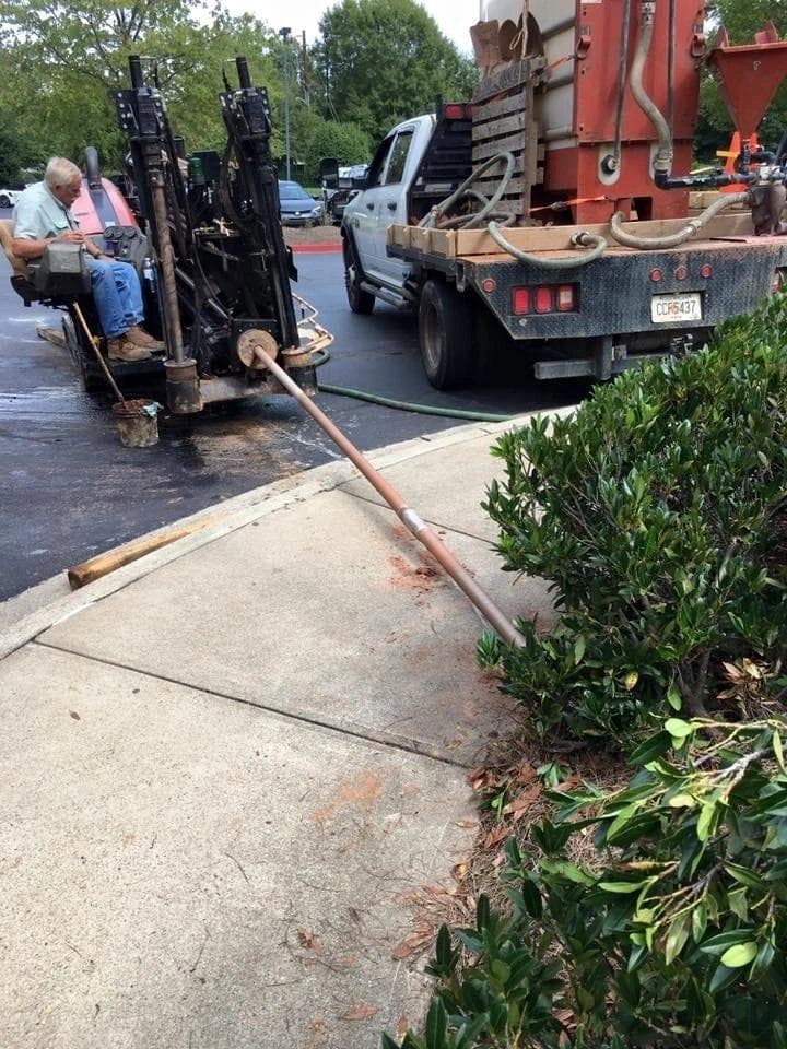 HDPE conduit installed under landscaping and sidewalk with directional drilling